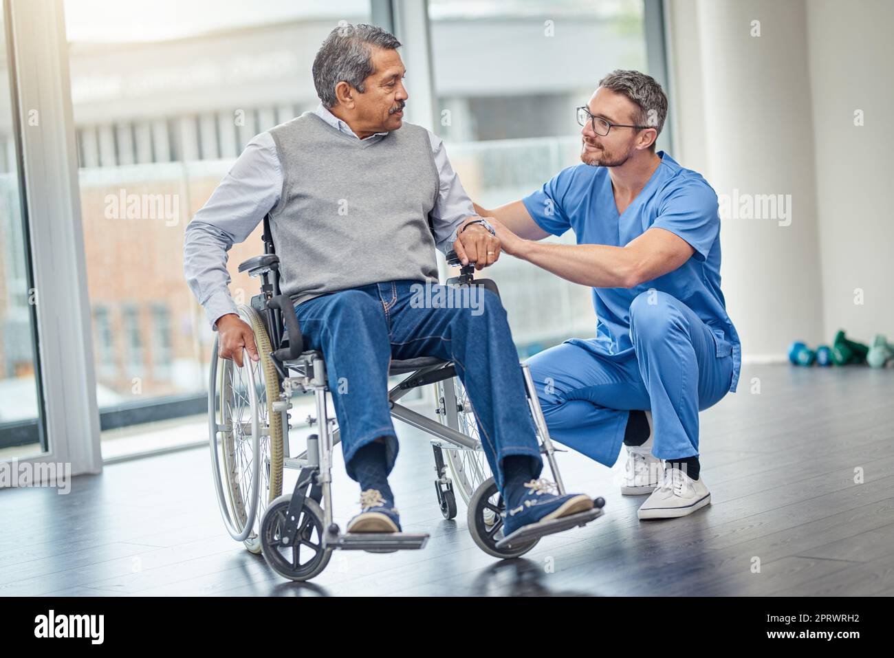 How are you finding your new wheelchair. a nurse helping a senior man
