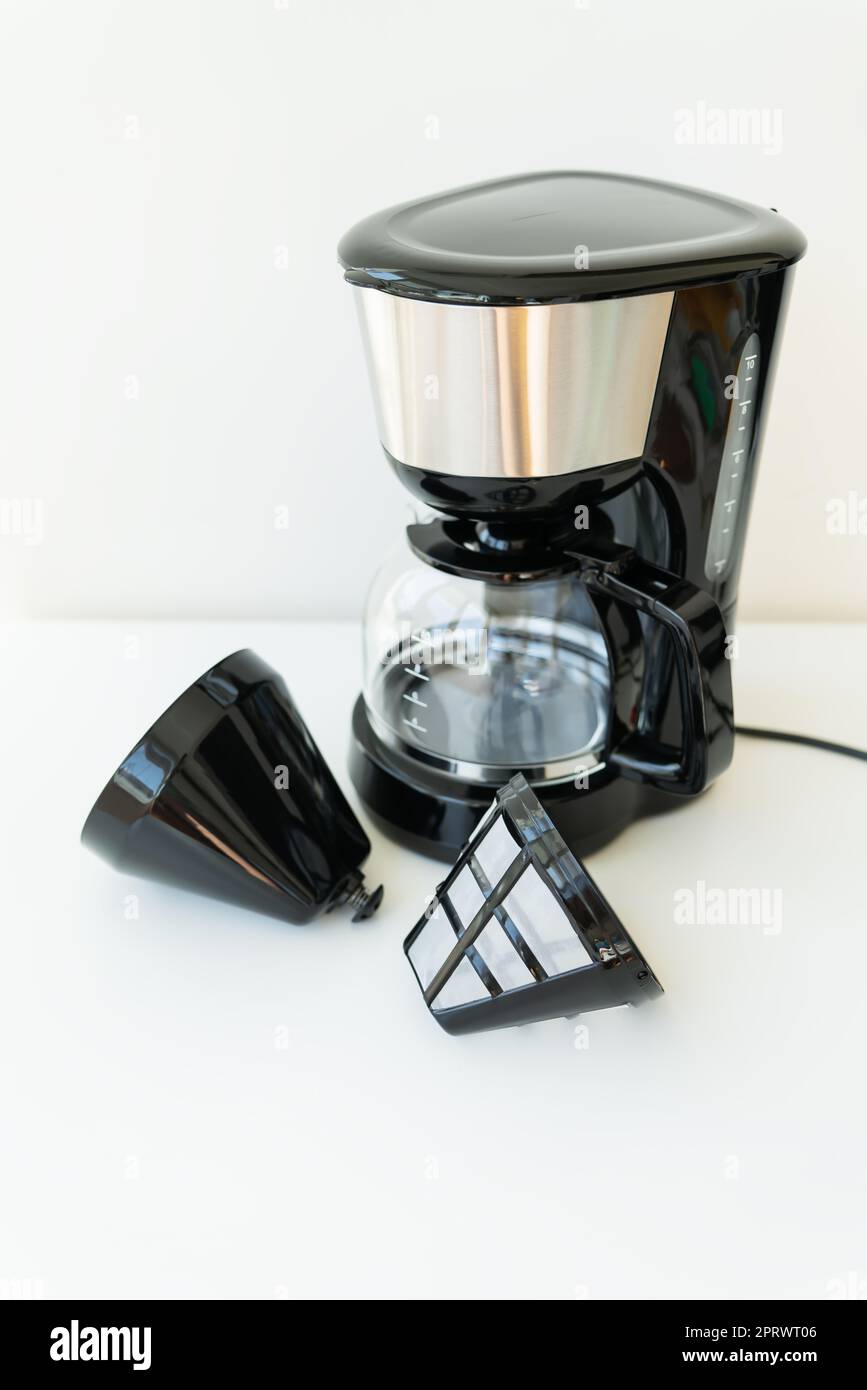 Automatic drip coffee maker isolated on white table. Black modern drip