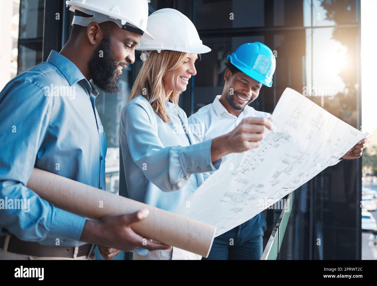 Architecture, construction building with an architect, engineer and designer working as a team and reading a blueprint. Teamwork, collaboration and development with a group of creative staff Stock Photo