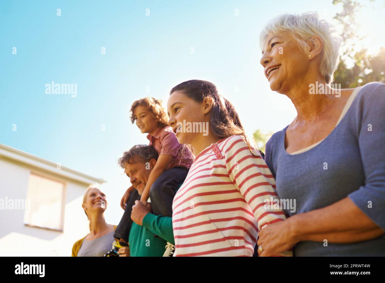 Standing together as a family. Low angle shot of a family outdoors. Stock Photo