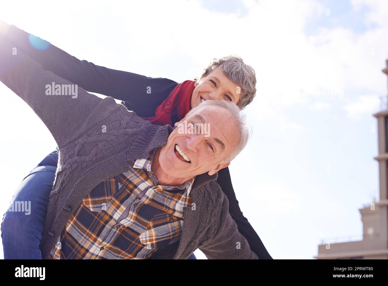 Never stop having fun. Portrait of a happy senior couple enjoying a piggyback ride outdoors. Stock Photo