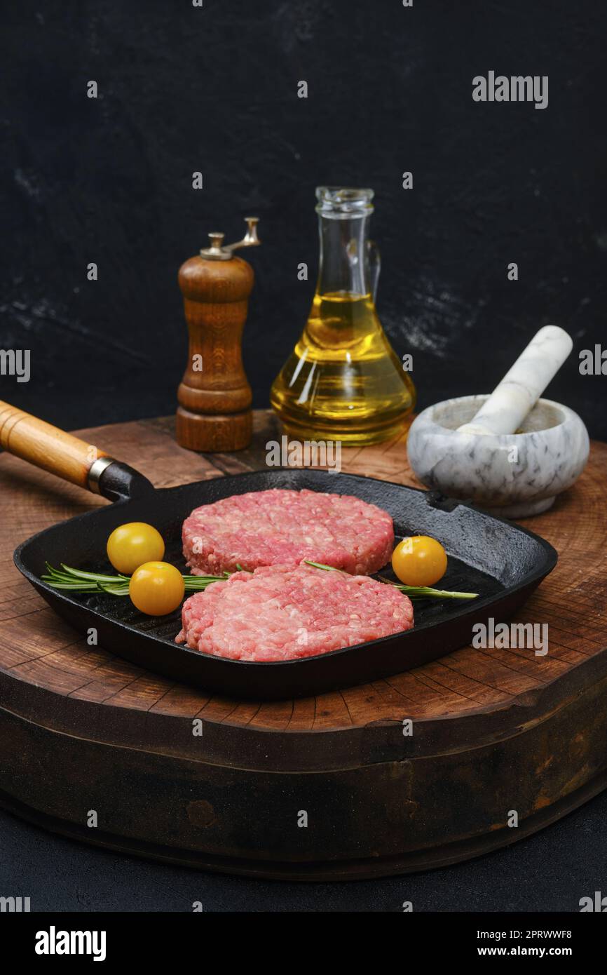 Raw beef burger patty on frying pan Stock Photo Alamy