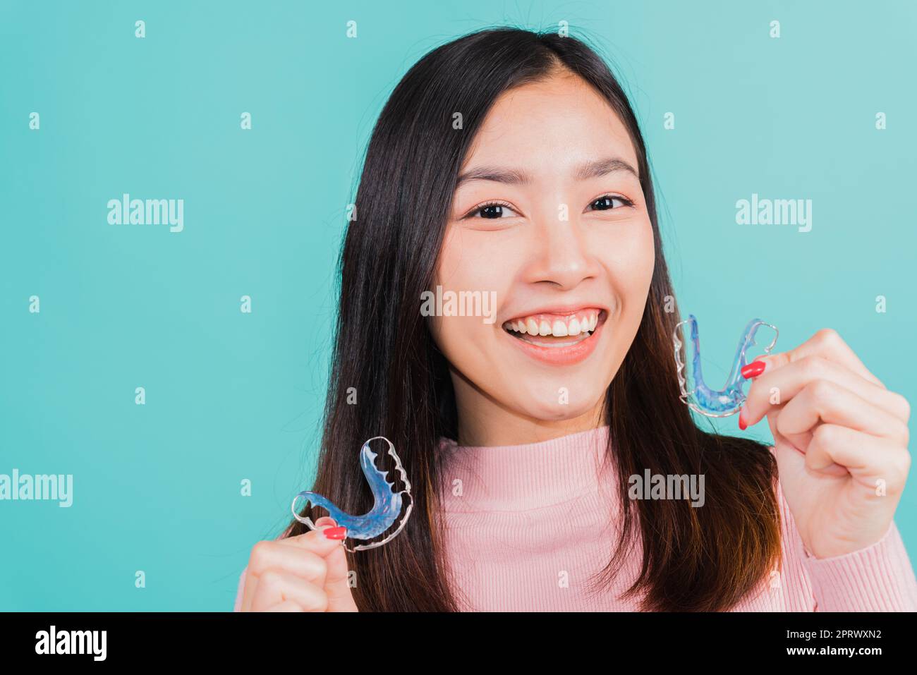 woman smiling hold silicone orthodontic retainers for teeth Stock Photo