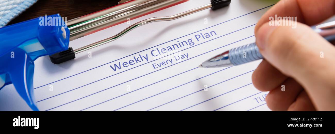 Person Hand Filling Weekly Cleaning Plan Form Stock Photo - Alamy
