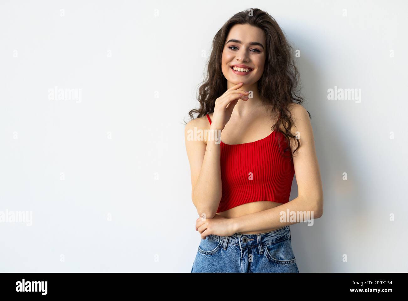 Portrait of a pretty smiling woman posing isolated on a white ...