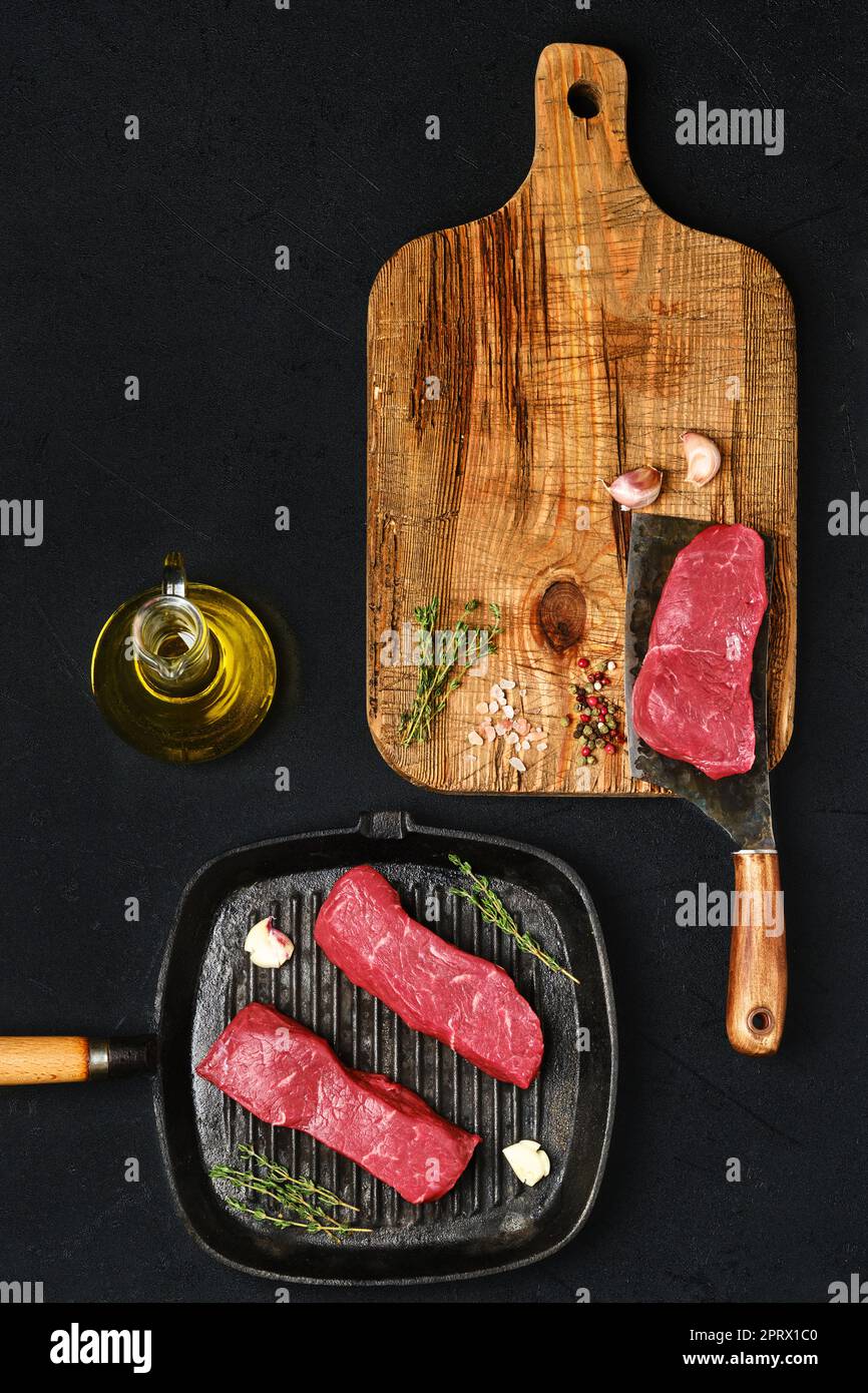 Overhead view of raw boneless beef strip steak ready for frying Stock