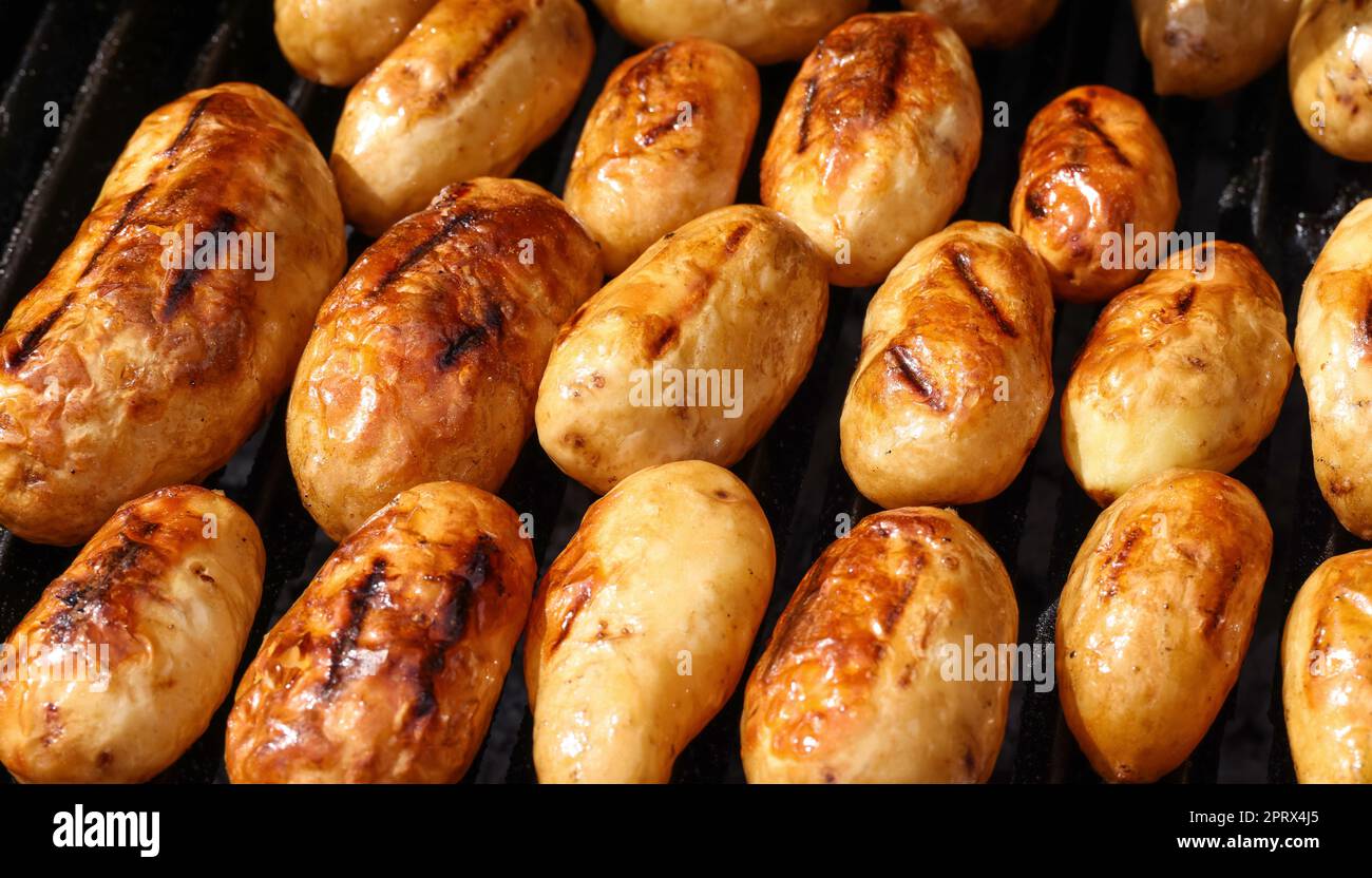 Cooking new potato in charcoal grill Stock Photo Alamy