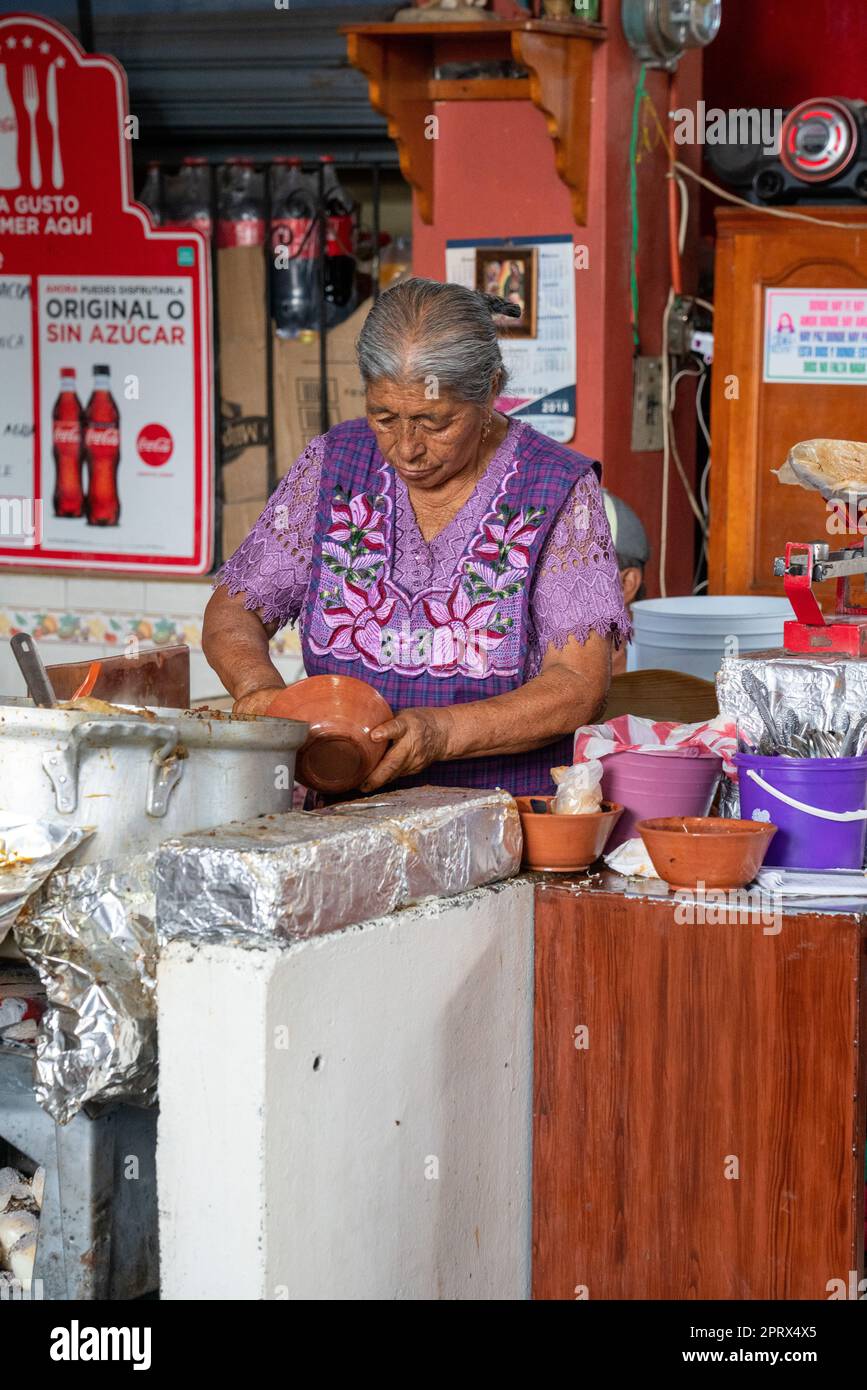 An Indigenous Zapotec Woman In Traditional Dress Cooks In The Market In