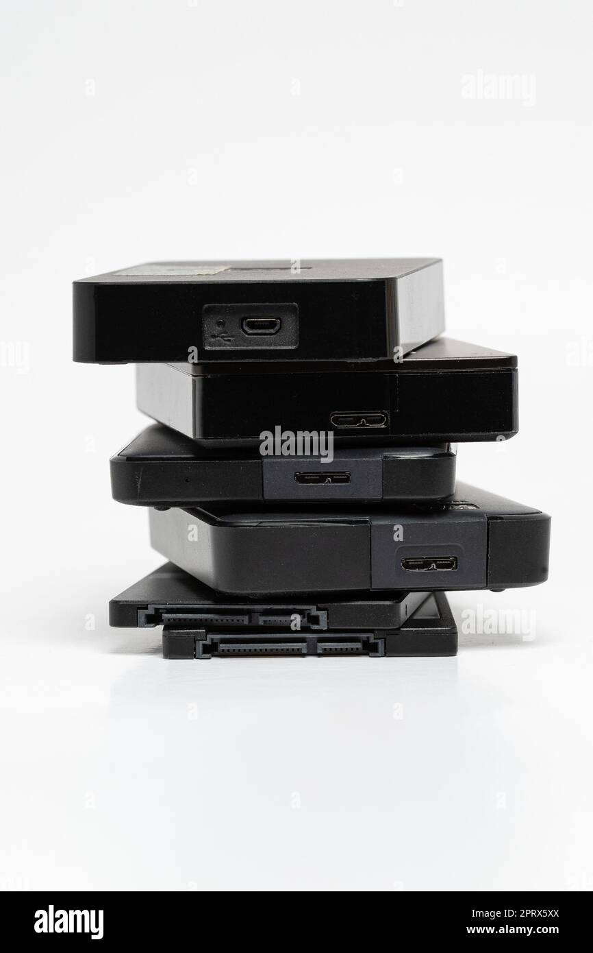 A stack of external USB hard drives on a white background Stock Photo