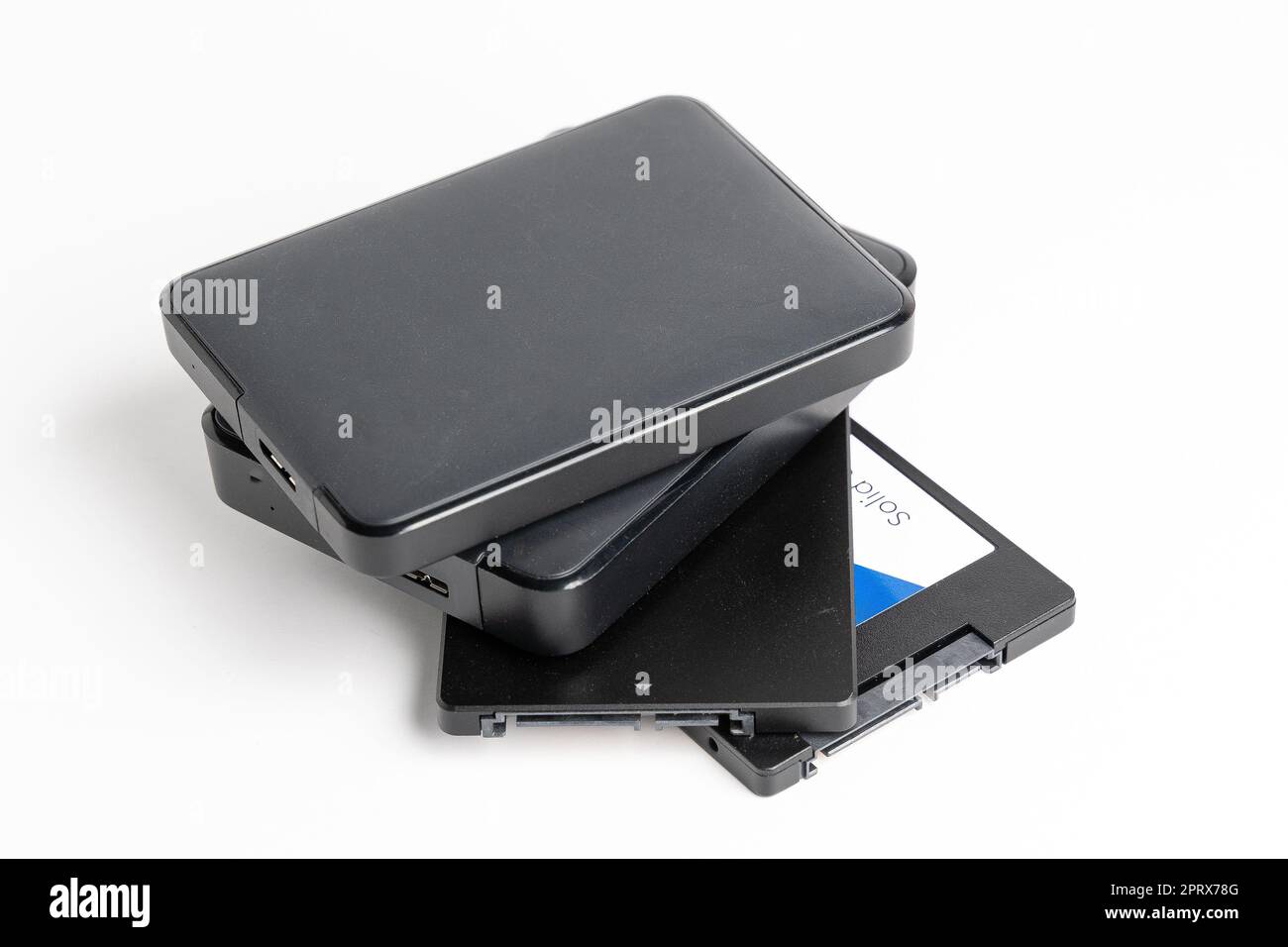 A stack of external USB hard drives on a white background Stock Photo