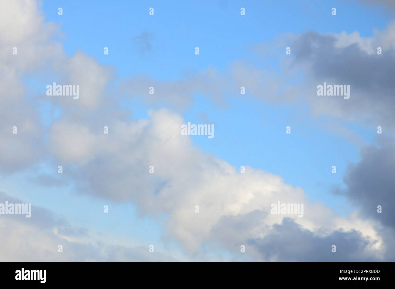A blue sky with lots of white clouds of different sizes Stock Photo - Alamy