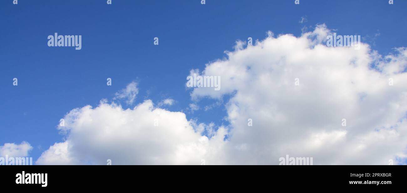 A blue sky with lots of white clouds of different sizes Stock Photo - Alamy