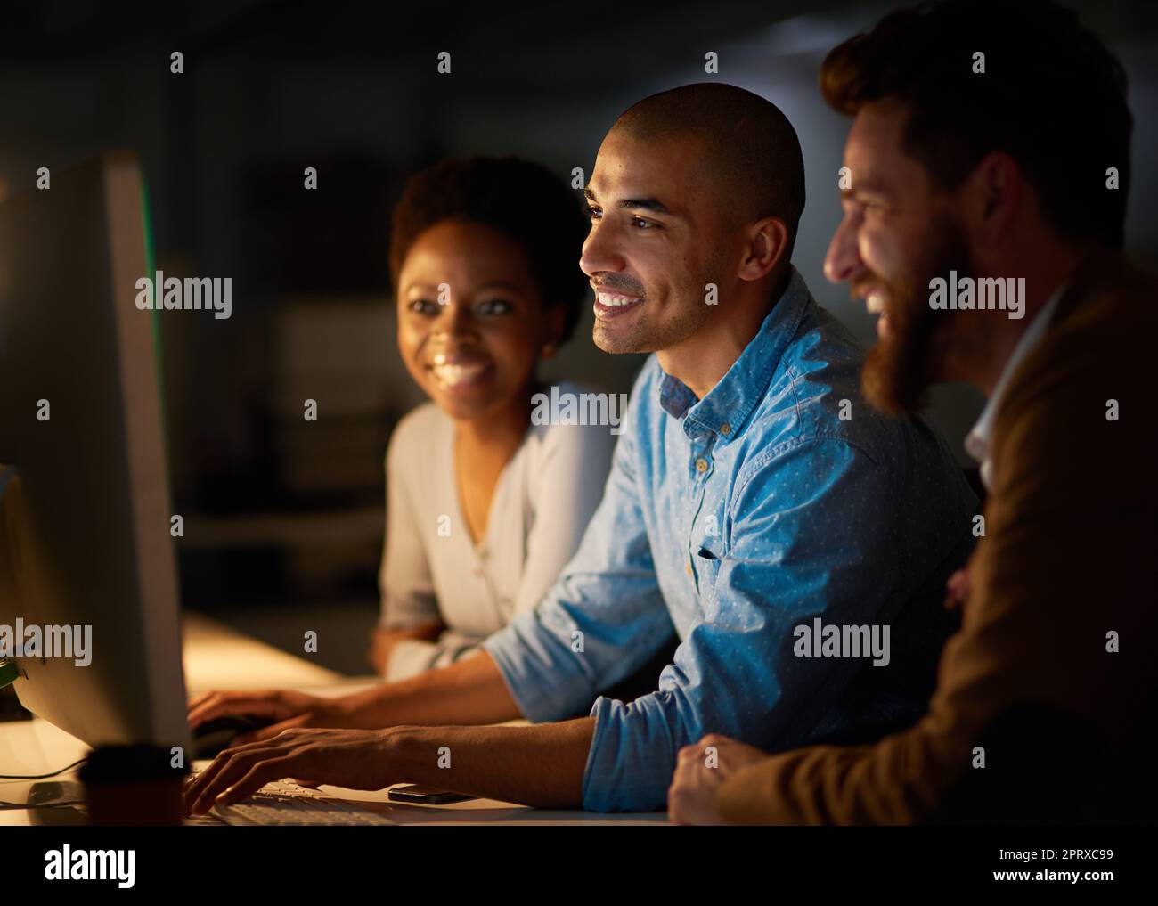 Were so close to knocking out this deadline. a group of colleagues working late in an office Stock Photo