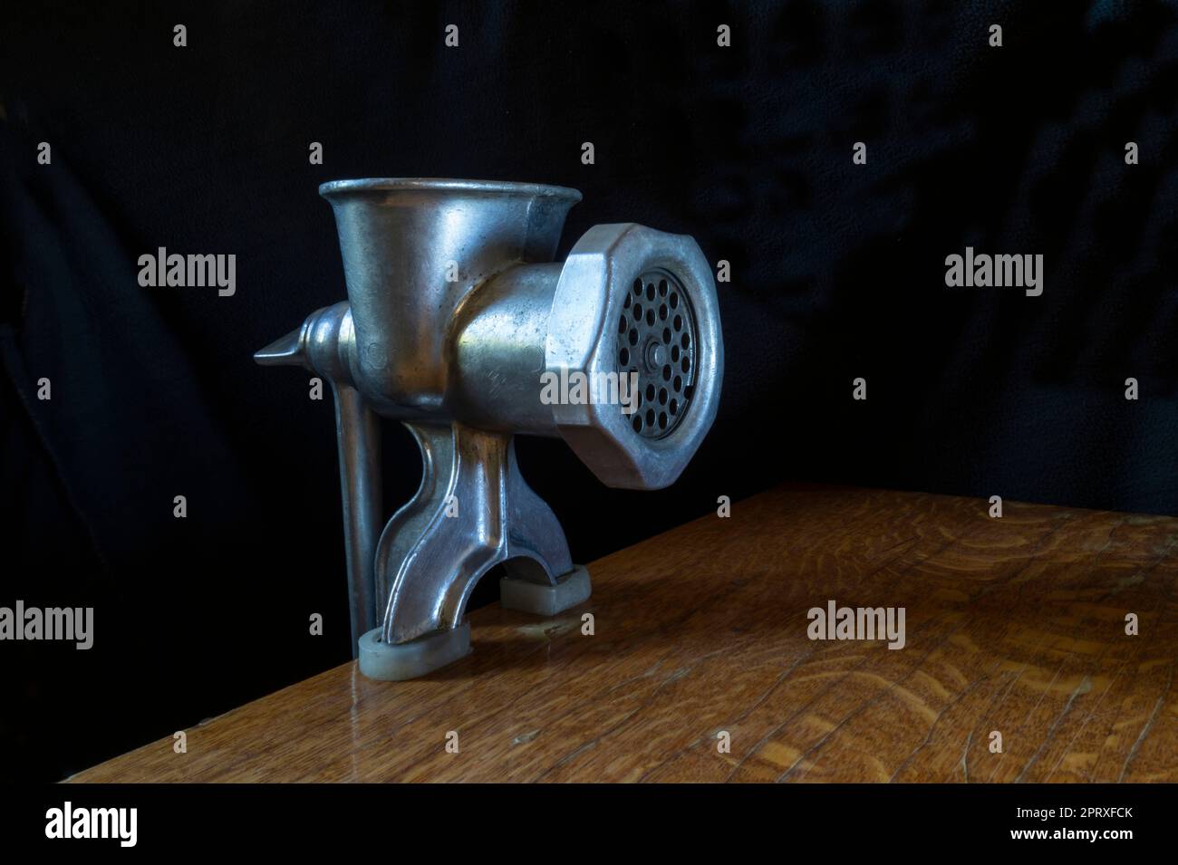 A home tool for meat processing. Kitchen items on a black background Stock Photo