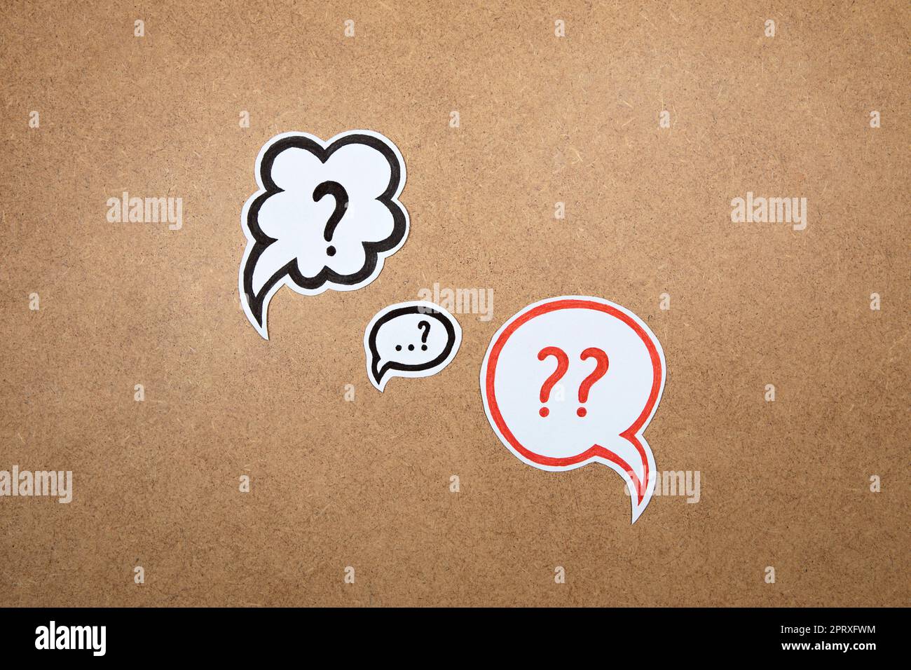 Question marks in speech bubbles. Paper shape of bubble with hand drawn interrogation points. Question concept, important information, dispute, hesita Stock Photo