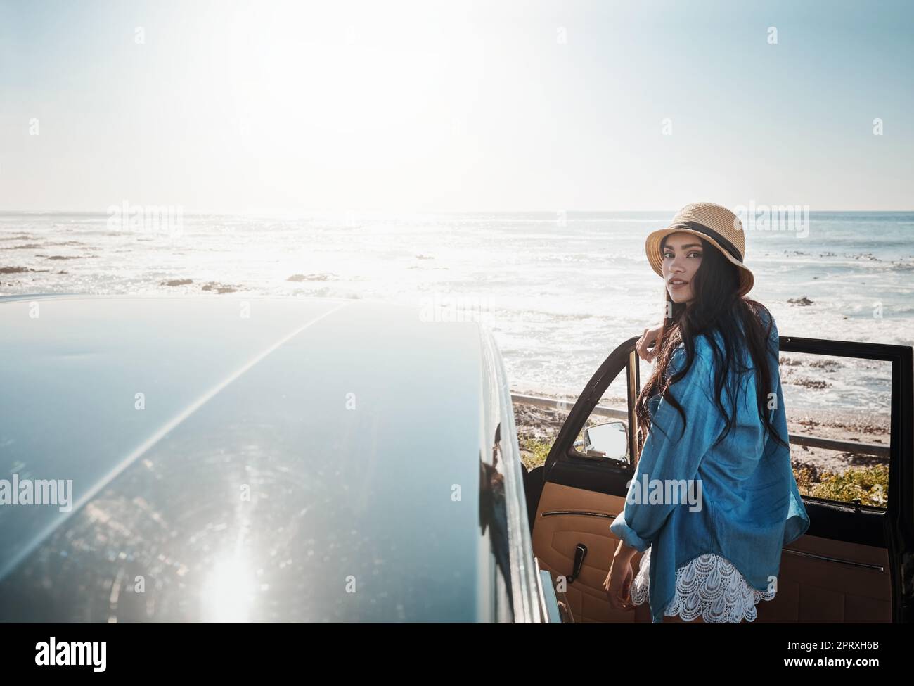 Summers the season for beautiful road trips. a young woman enjoying a ...