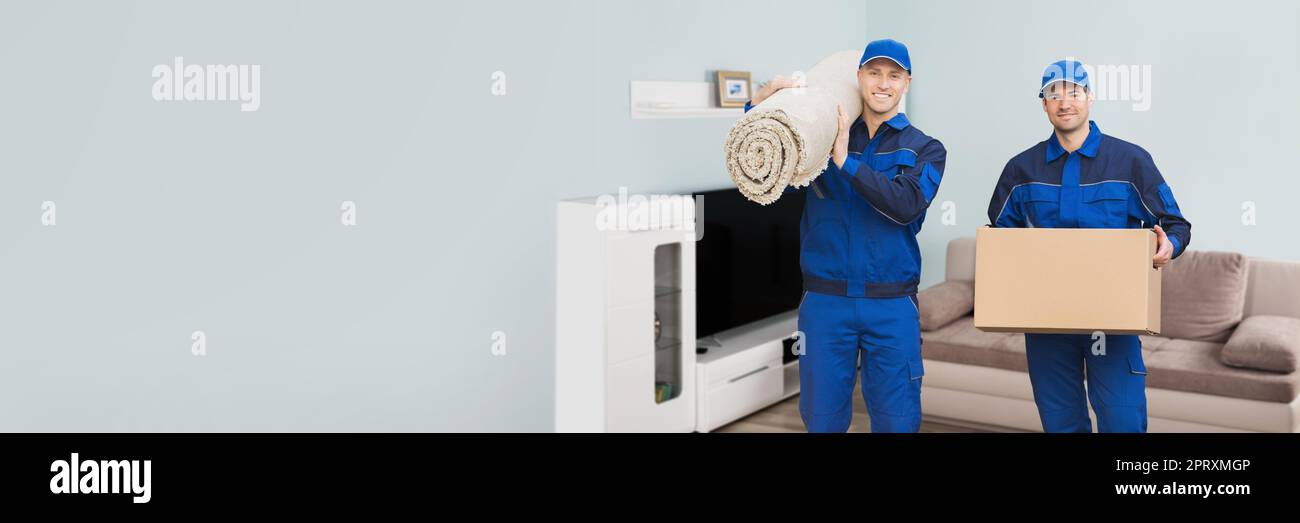 Furniture Move. Movers Carrying And Lifting Carpet And Box Stock Photo
