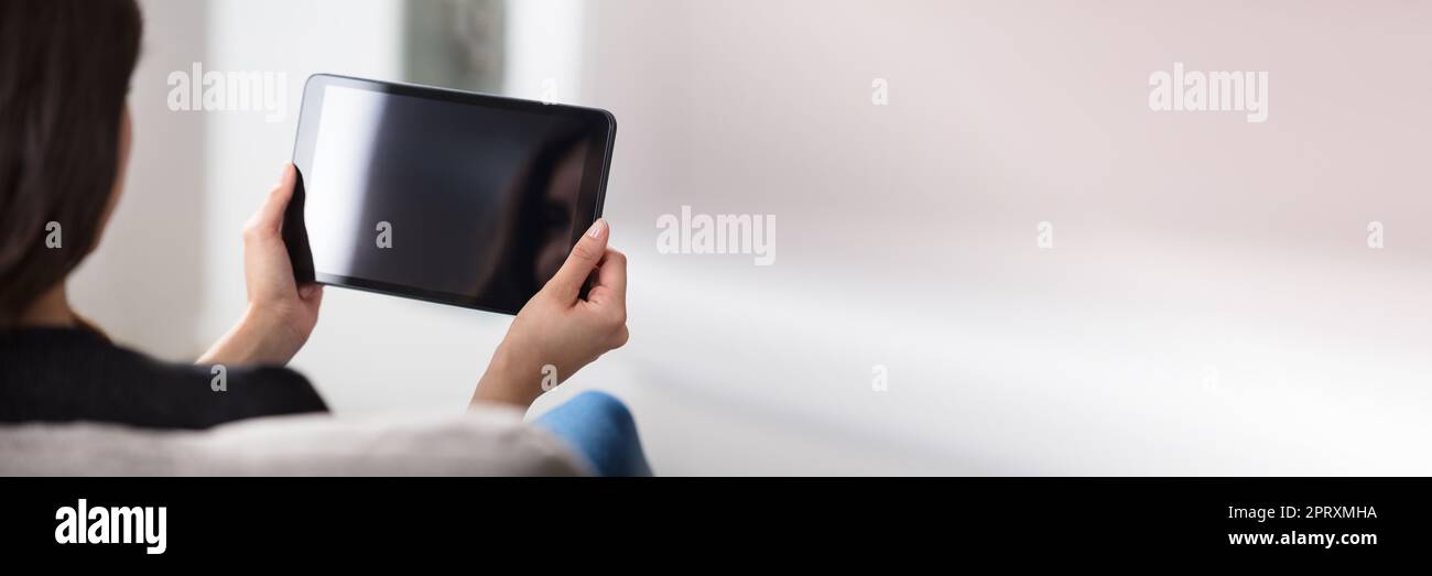 Woman Using Digital Tablet At Home. Holding Blank Touchscreen Stock Photo