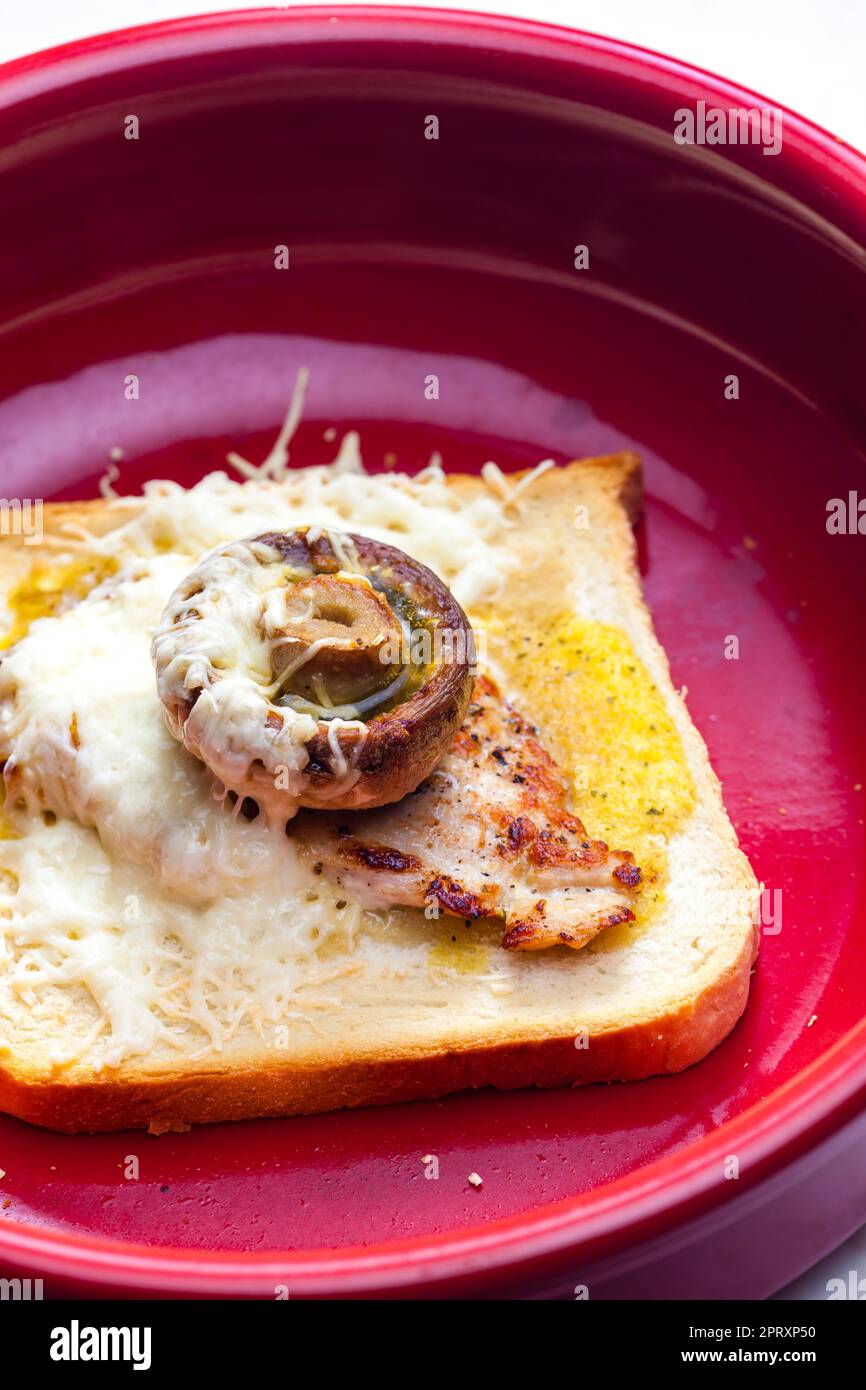 slice of toast bread grilled with meat, champignon and cheese Stock