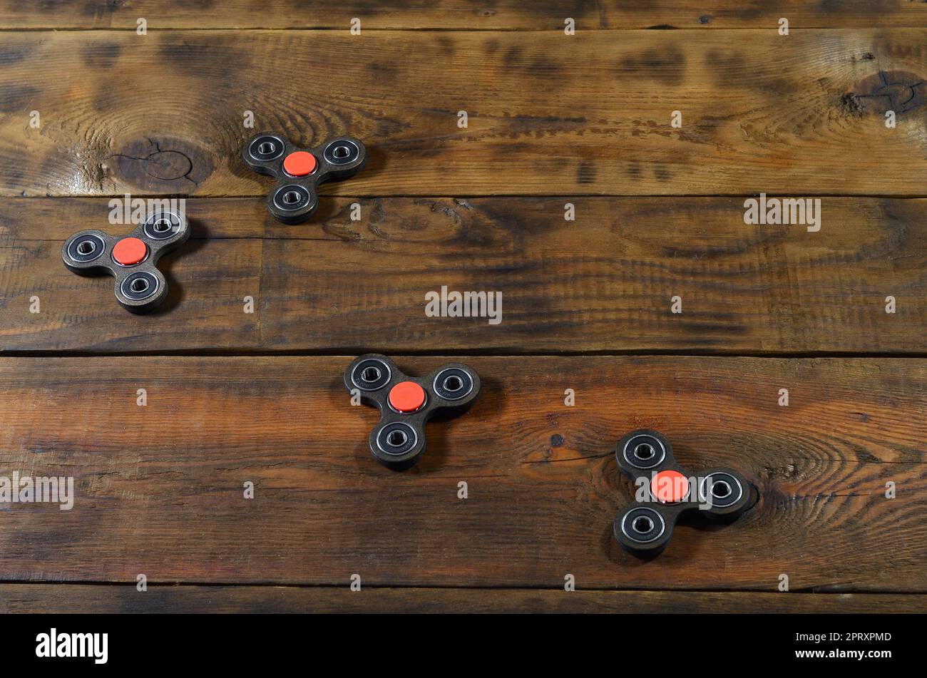 A rare handmade wooden fidget spinners lies on a brown wooden ...