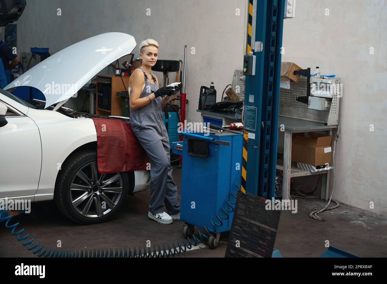 Young woman mechanic stands hi-res stock photography and images - Alamy