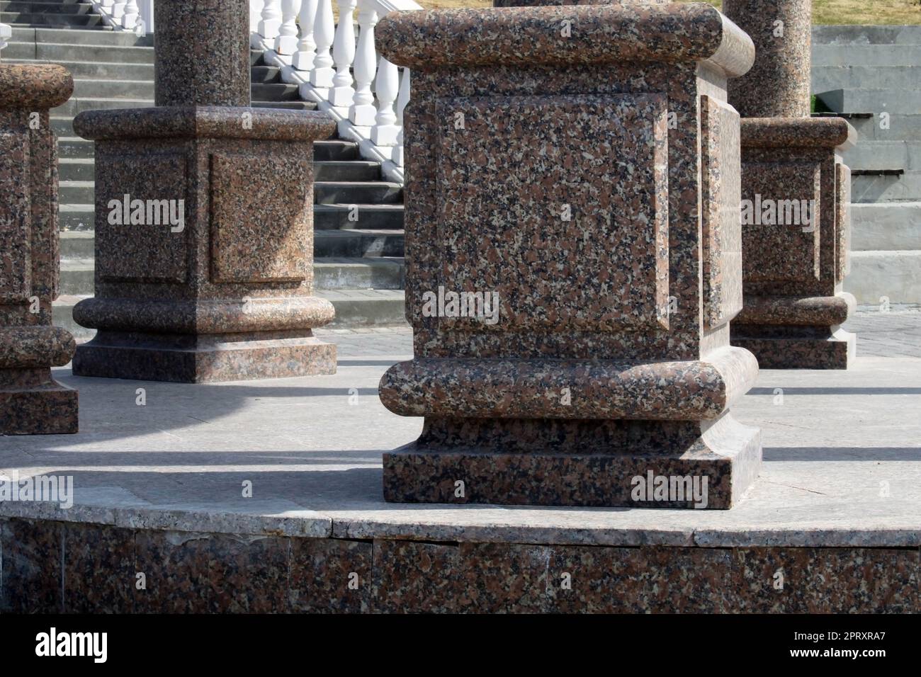 Large Brown Rounded Columns Large brown marble columns close-up on the background of the stairs in ...