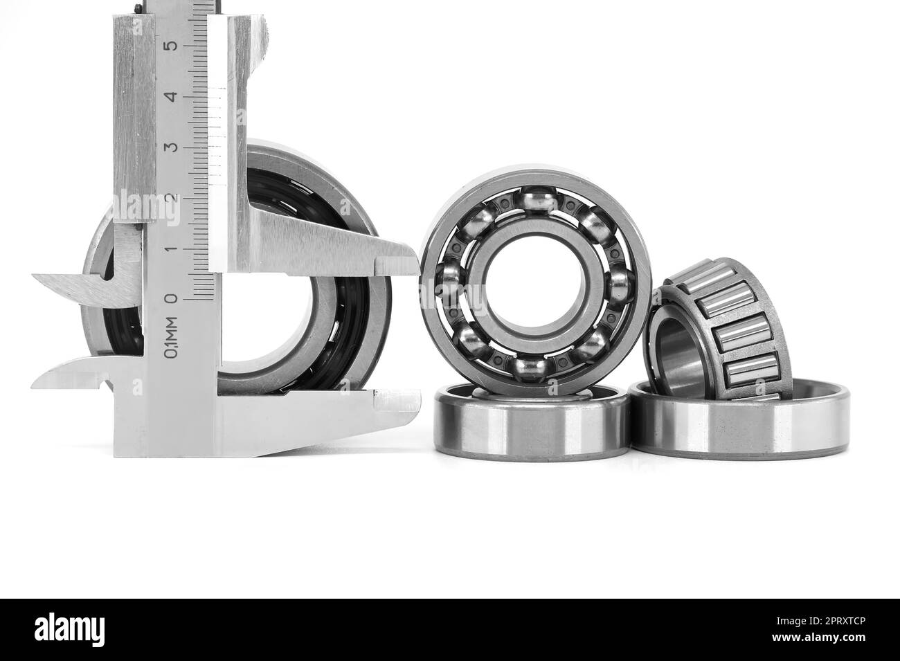 Measure caliper and roller bearings on white background. Mechanical