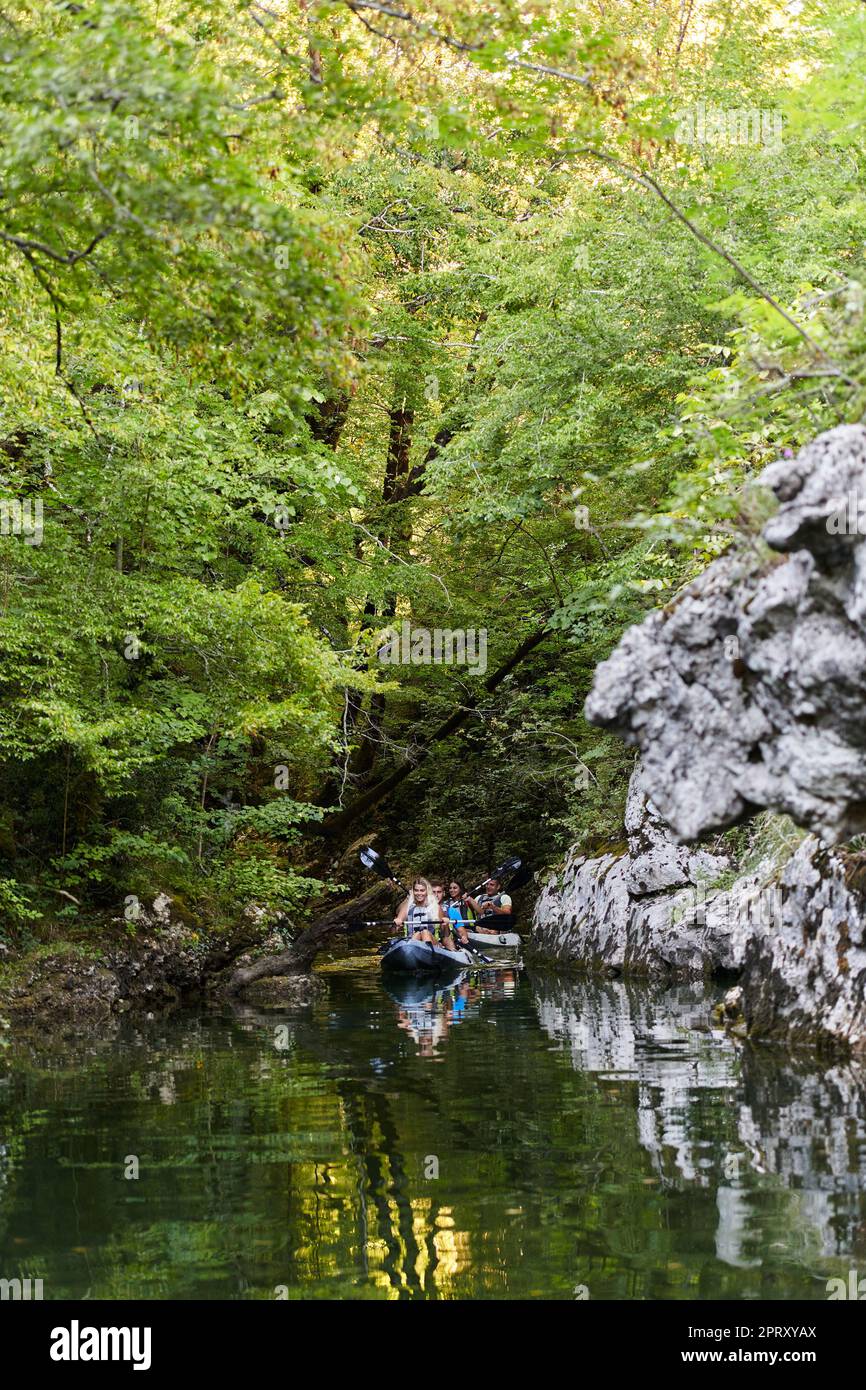 A young couple enjoying an idyllic kayak ride in the middle of a ...