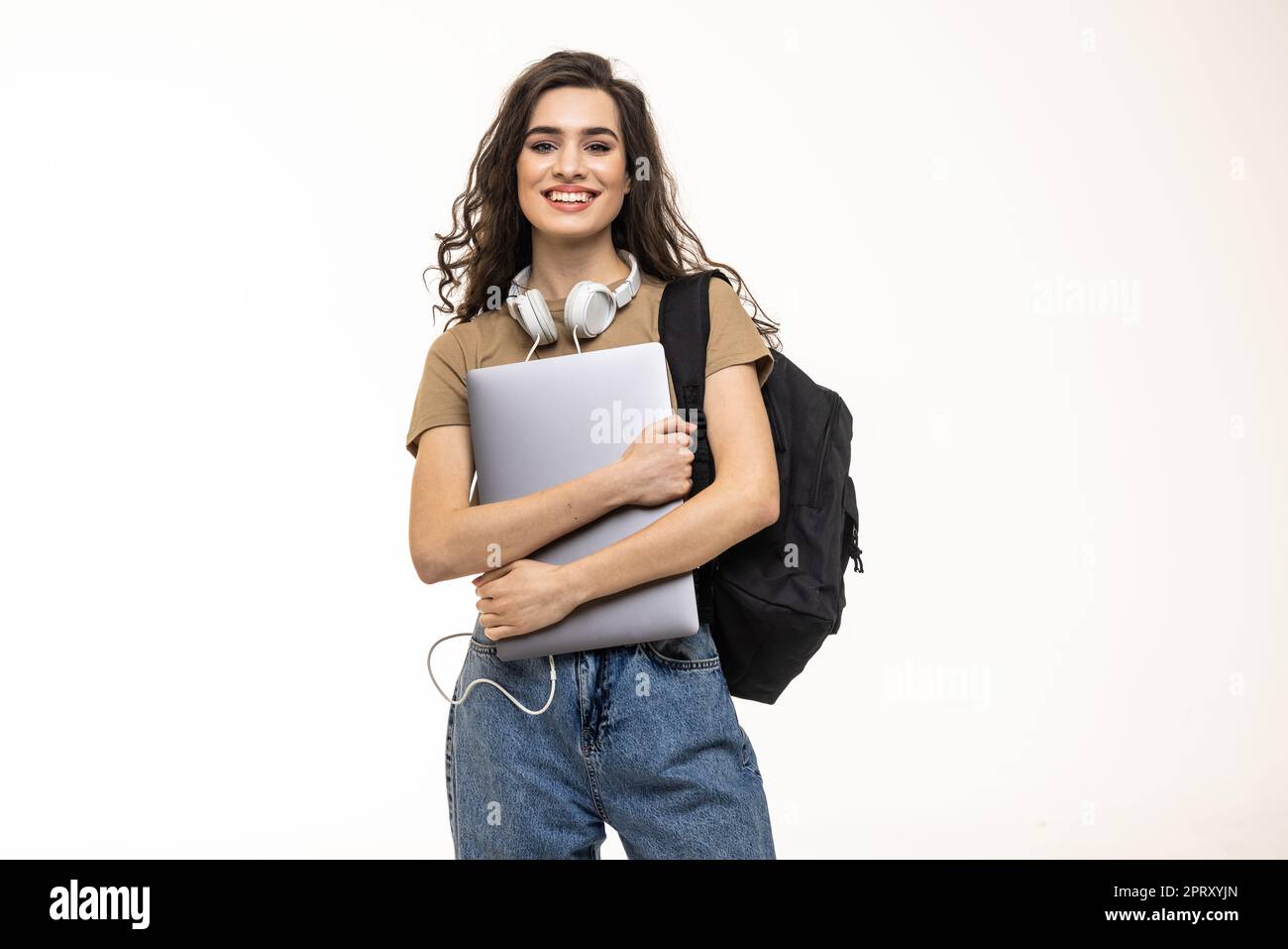 Portrait of a pretty girl carrying backpack standing isolated over white background holding laptop computer Stock Photo Alamy