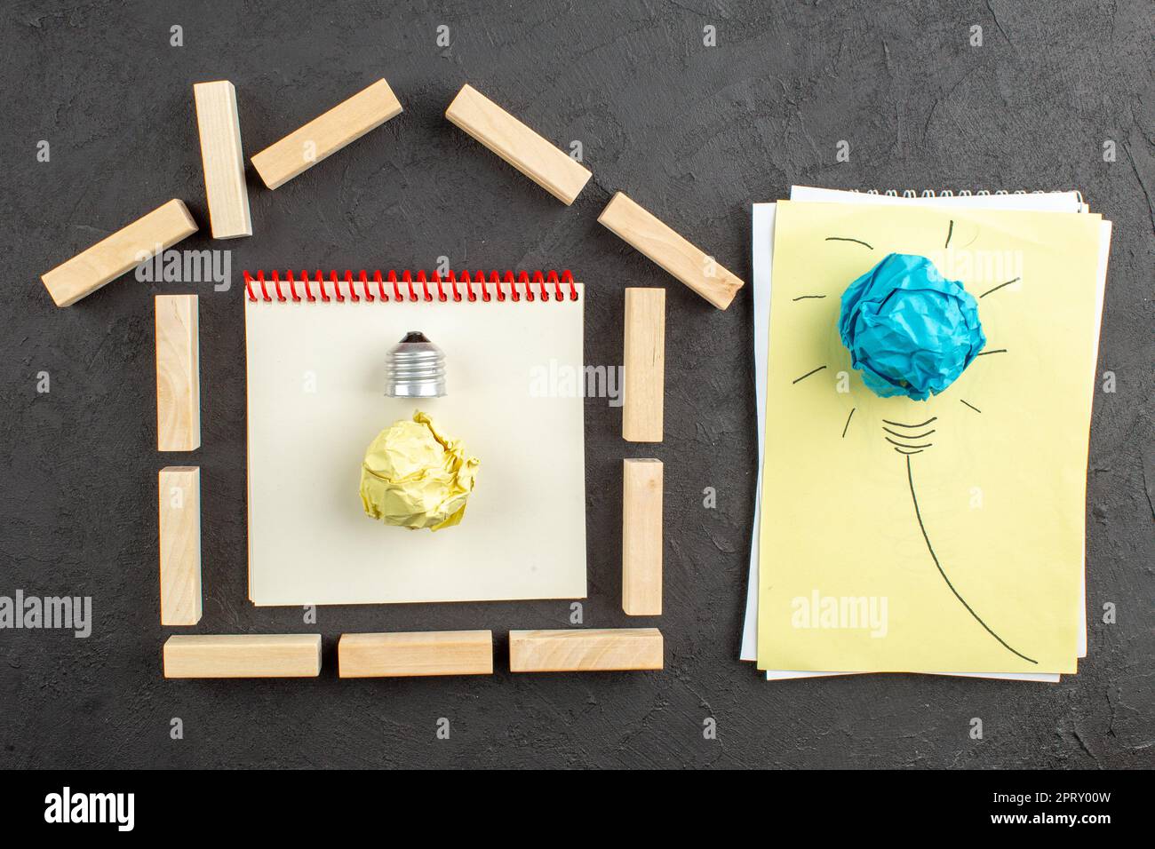 top view house shaped wood blocks goals written on notepad idealight