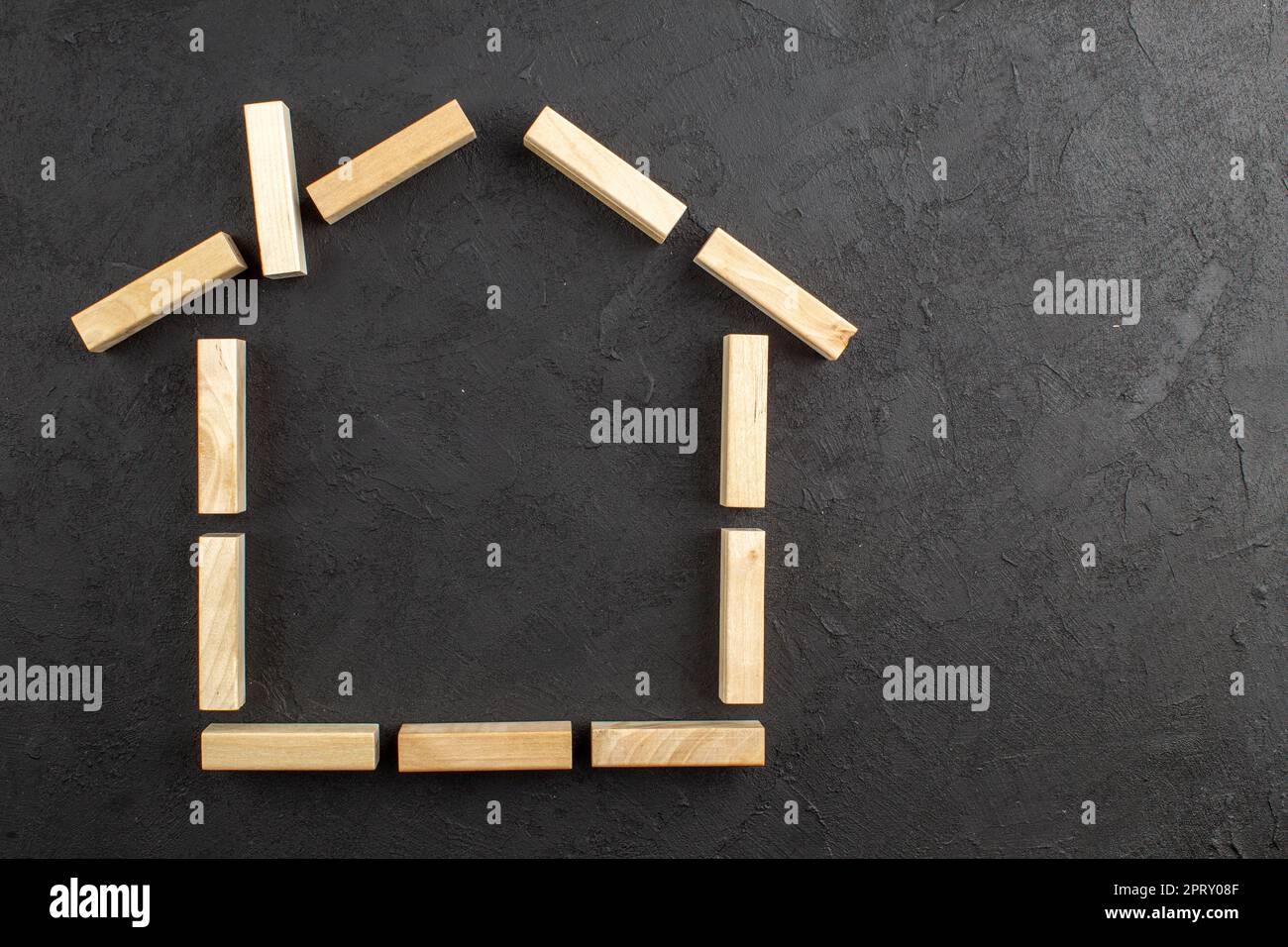 top view house shaped wood blocks on black background copy place Stock