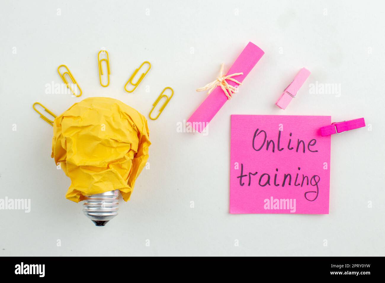 top view online training written on pink sticky note idealight bulb on ...