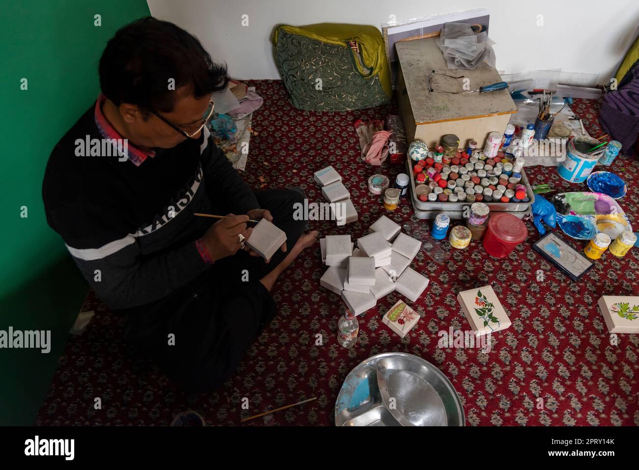 An artisan is seen designing an item with Paper Mache at his in Srinagar. PapierMache