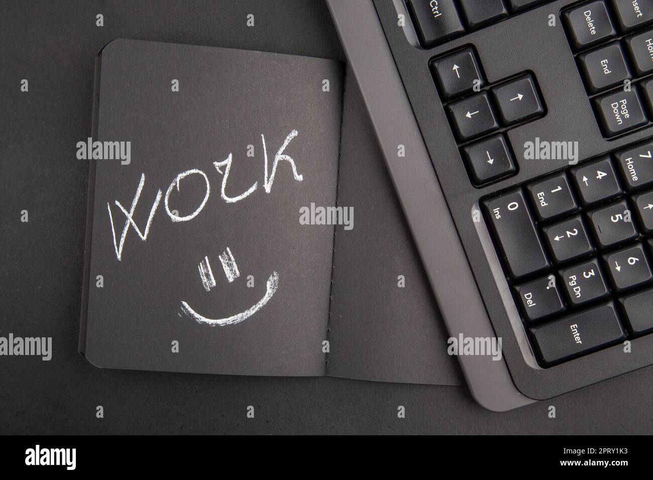 top view work written on black notebook keyboard on dark background Stock Photo