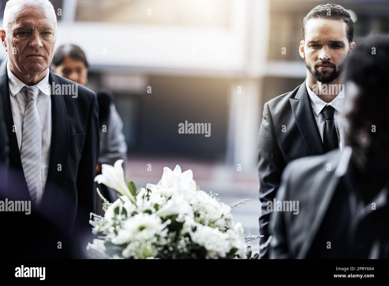Man, funeral and carrying coffin in grief for loss, death or sorrow