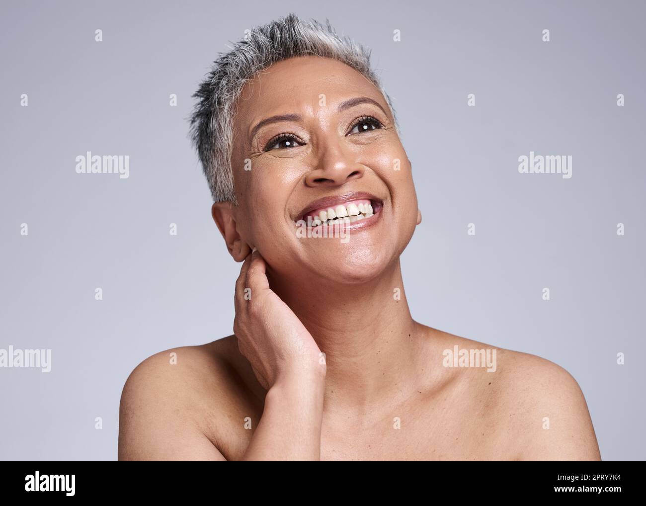 Face, beauty and antiaging with a senior woman in studio on a gray background to promote natural skincare. Wellness, luxury and cosmetics with a matur Stock Photo