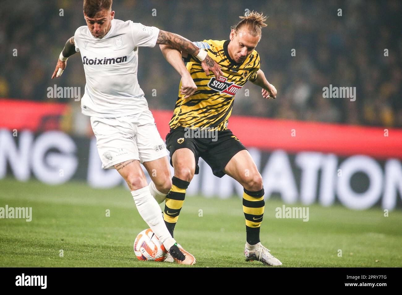 Athens, Greece. 26th Apr, 2023. AEK's player Domagoj Vida (Right) and PAOK's  Brandon Thomas (Left) fight for the ball during a Greek Superleague  Playoffs soccer game between AEK FC and PAOK FC. (