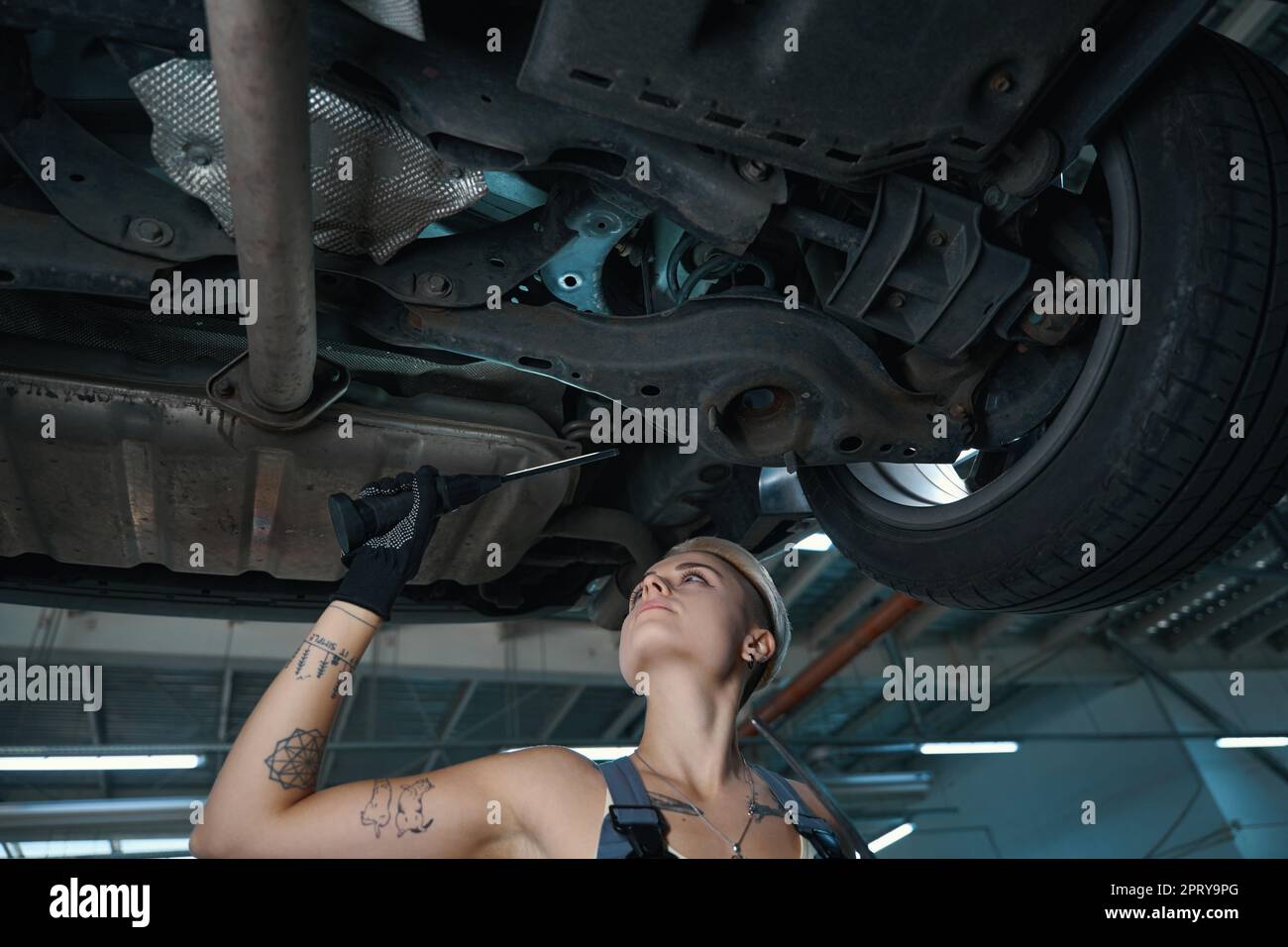 Young woman works on engine hi-res stock photography and images - Alamy