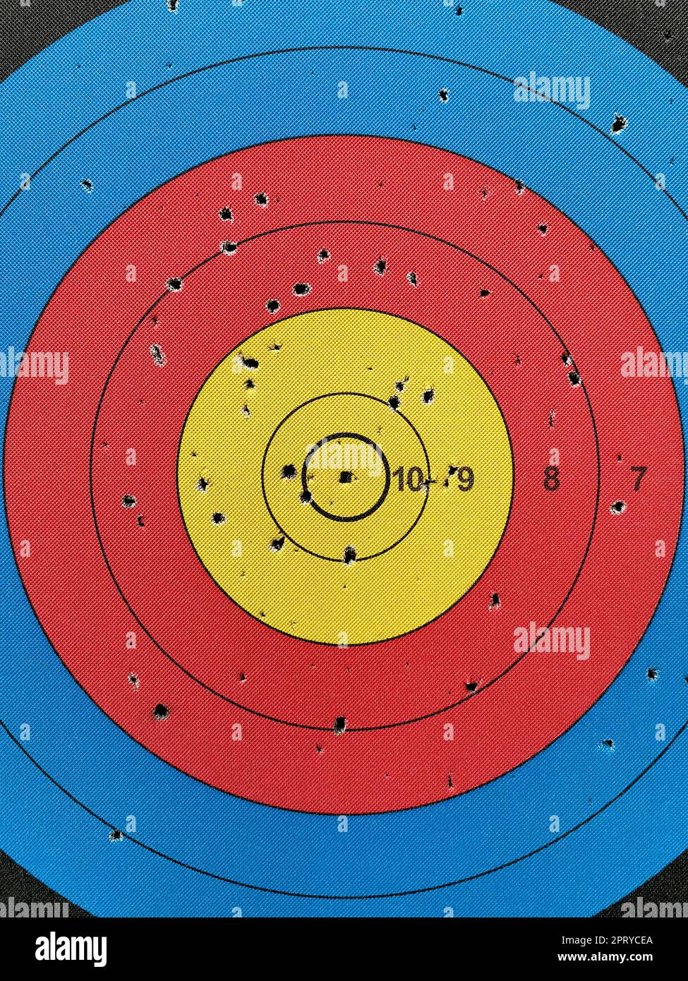 Numbered used dart board with number and full of dart holes Stock Photo