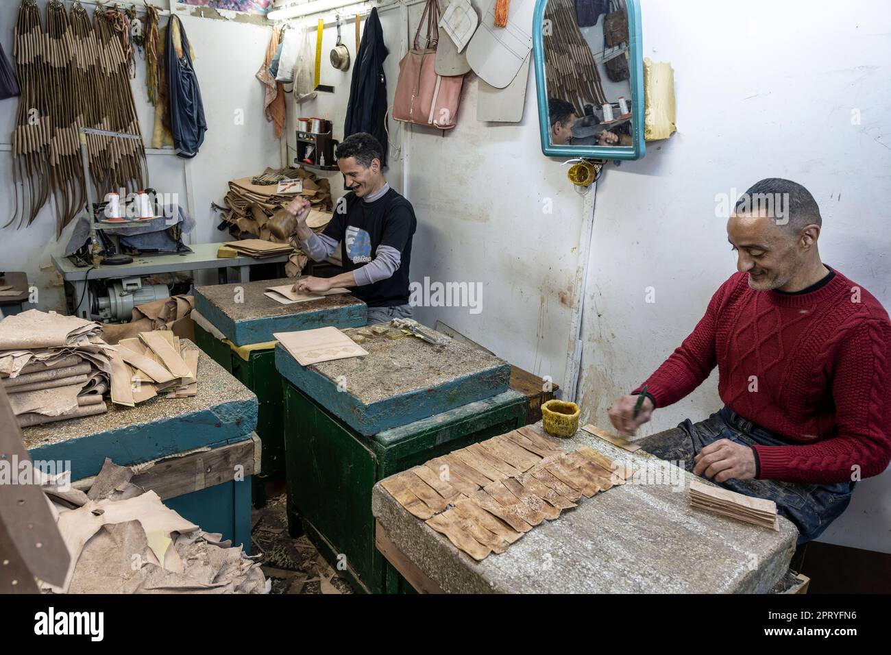 Craftsmen working leather in a small workshop in the Tetouan medina. Stock Photo
