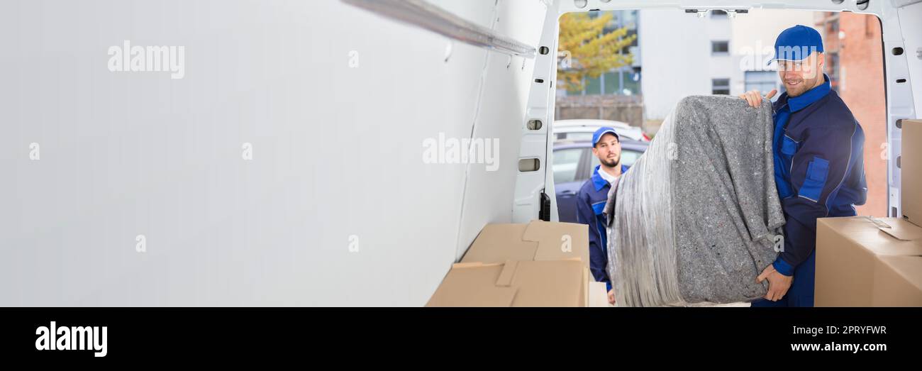 Happy Movers Unloading Furniture From Truck. Mover Service Stock Photo
