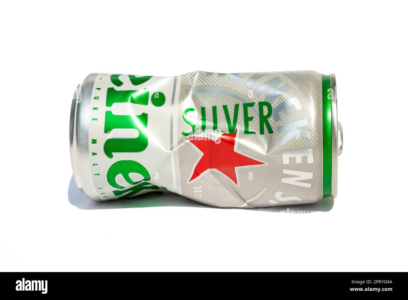 Ho Chi Minh City, Vietnam - April 25, 2023: Crushed aluminum beer can with the Heineken logo isolated on white. Opened empty crumpled can of a famous Stock Photo