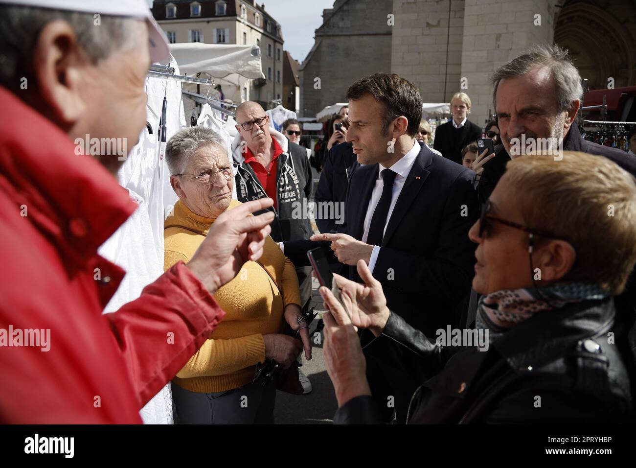 La Cluze-et-Mijoux, France, 27 April 2023. French President Emmanuel Macron (CR) visits the Dole market and meets people before to visit the 'Chateau de Joux' upon a ceremony of the 175th anniversary of the abolition of slavery in France, in Dole, Eastern France, 27 April 2023. To commemorate slavery's abolition French President Macron pay tribute to Toussaint Louverture, imprisoned at the 'Chateau de Joux' until the end of his life, for the anniversary of his birth (280th) and his death (220th) celebrated this year. Photo by Christophe Petit Tesson/Pool/ABACAPRESS.COM Stock Photo