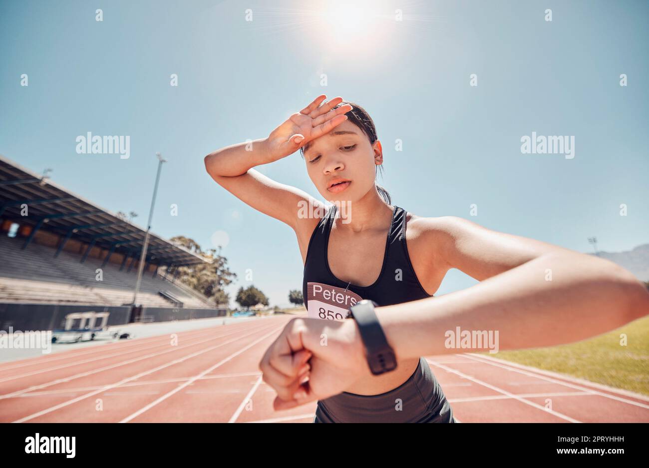 Woman, tired or smart watch check on running track fitness, workout or training for sprint marathon, training challenge or race event. Stress, sweatin Stock Photo