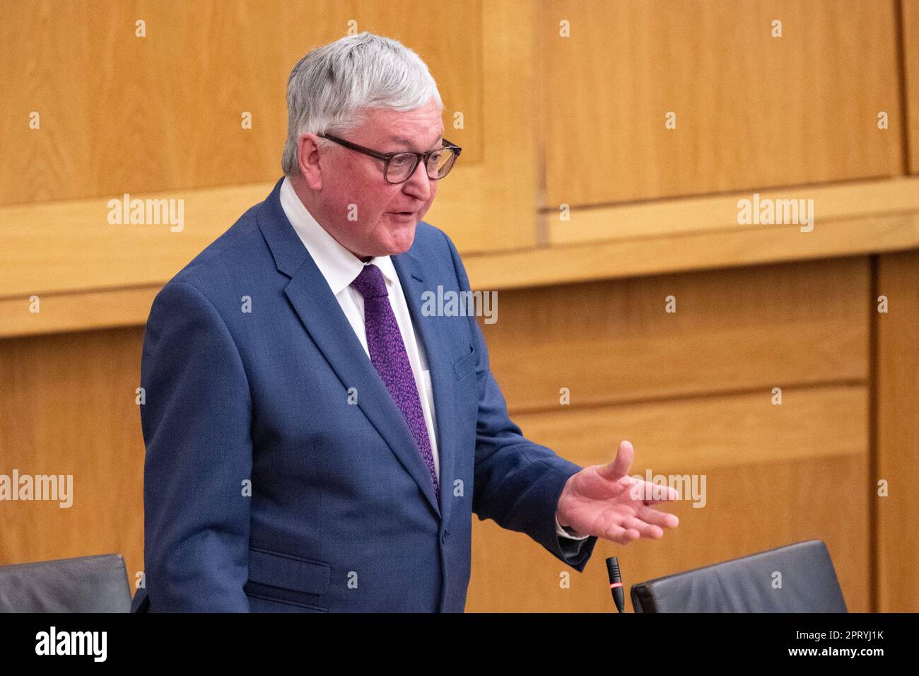 Edinburgh, Scotland, UK. 27th Apr, 2023. PICTURED: Fergus Ewing MSP of the Scottish National Party (SNP), asking question about when the A9 will be finished being duelled to duel carriage way. Weekly session of First Ministers Questions as Humza Yousaf MSP, First Minister of Scotland takes questions in the chamber. Scenes also inside the corridor before and after FMQs. Credit: Colin Fisher/Alamy Live News Stock Photo