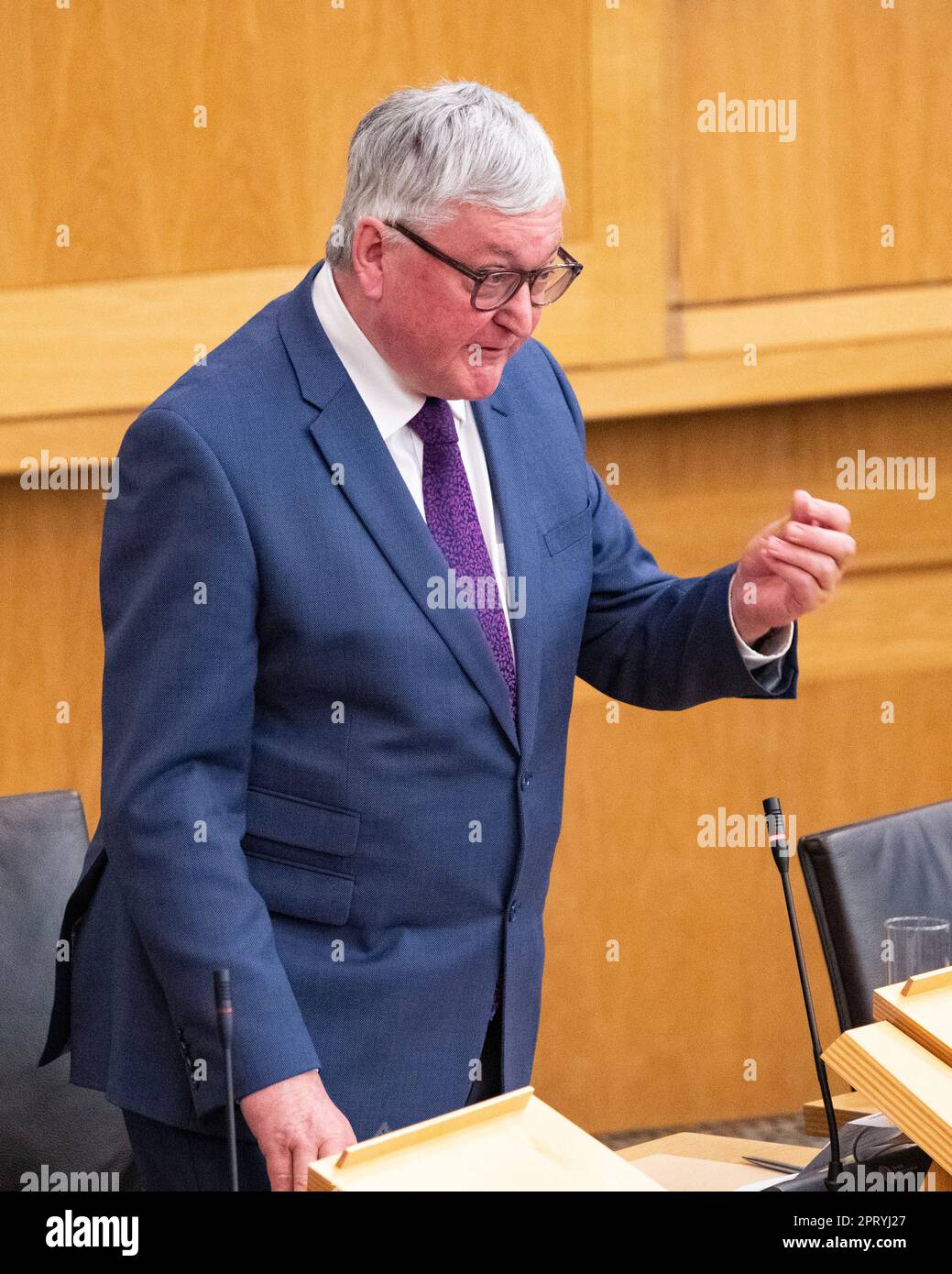 Edinburgh, Scotland, UK. 27th Apr, 2023. PICTURED: Fergus Ewing MSP of the Scottish National Party (SNP), asking question about when the A9 will be finished being duelled to duel carriage way. Weekly session of First Ministers Questions as Humza Yousaf MSP, First Minister of Scotland takes questions in the chamber. Scenes also inside the corridor before and after FMQs. Credit: Colin Fisher/Alamy Live News Stock Photo