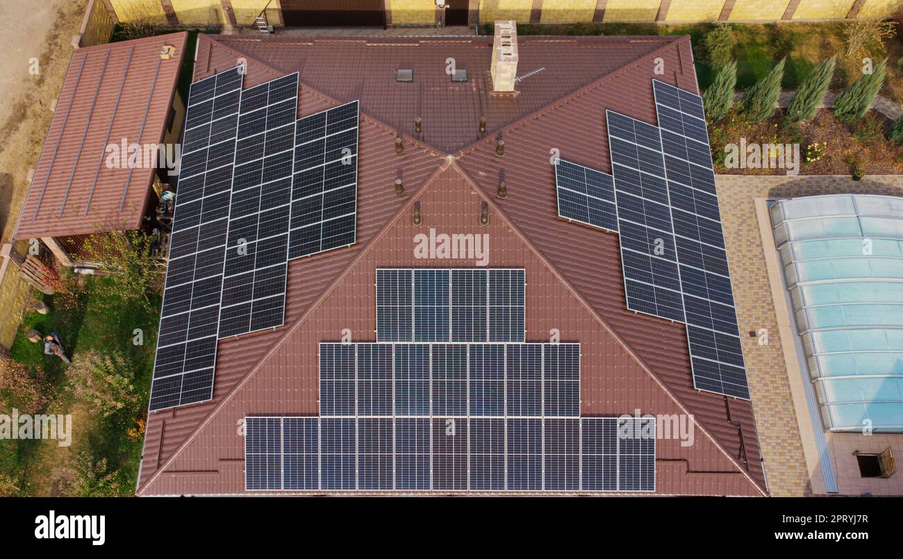 Row of blue solar panels on orange roof. Group of blue solar collectors ...
