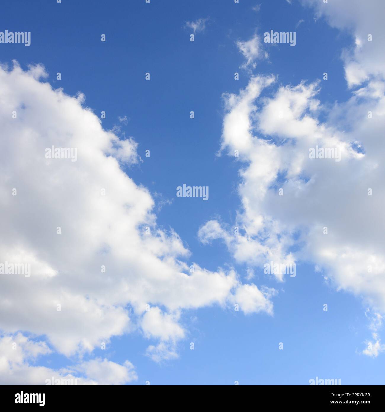 A blue sky with lots of white clouds of different sizes Stock Photo - Alamy
