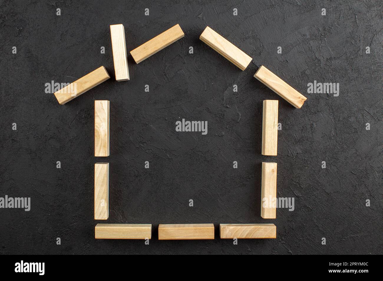 top view house shaped wood blocks on black background Stock Photo - Alamy