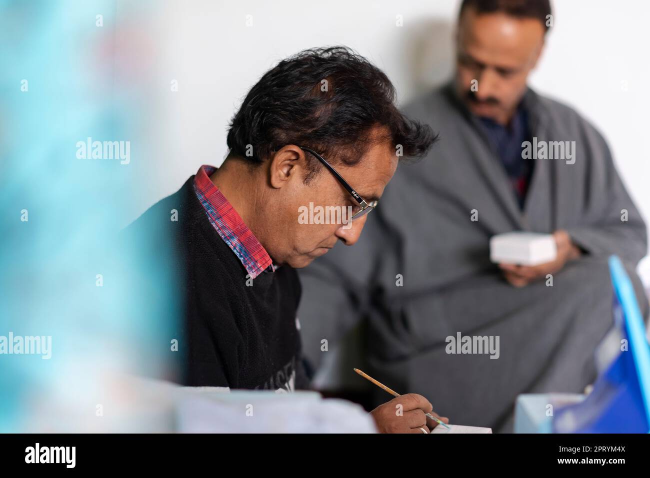 Artisans are seen decorating items with Paper Mache at their in Srinagar. PapierMache
